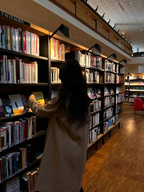 Woman enjoying a book in warm, cozy light
